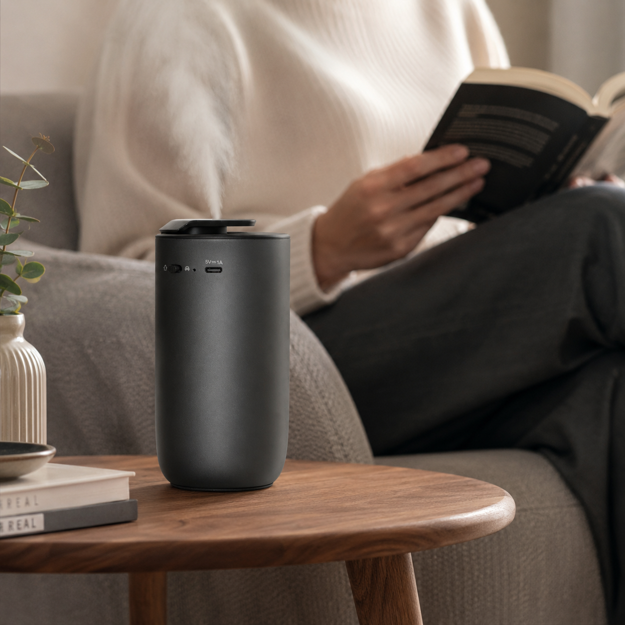 Compact black aroma diffuser in a calm living room